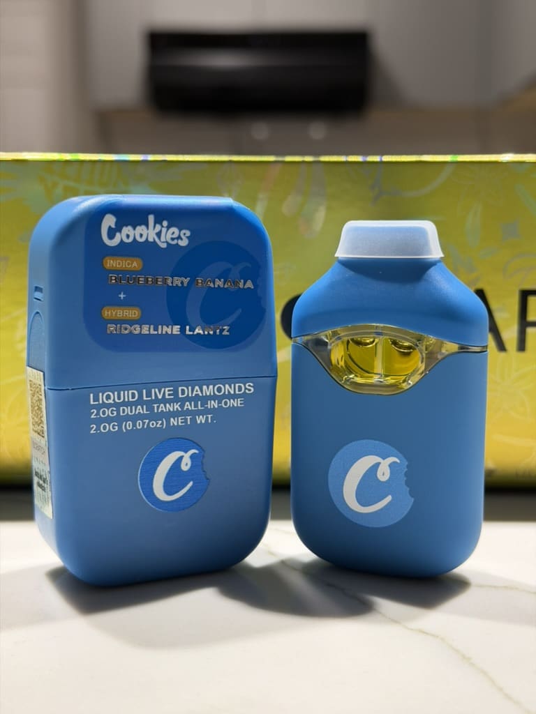 A21D978A-4E16-4A4C-B2B2-3E76CA4C333F_1_105_c.jpeg Cookies Dual Tank Disposable Vape – Blueberry Banana x Ridgeline Lantz | Indica x Hybrid - Image 1